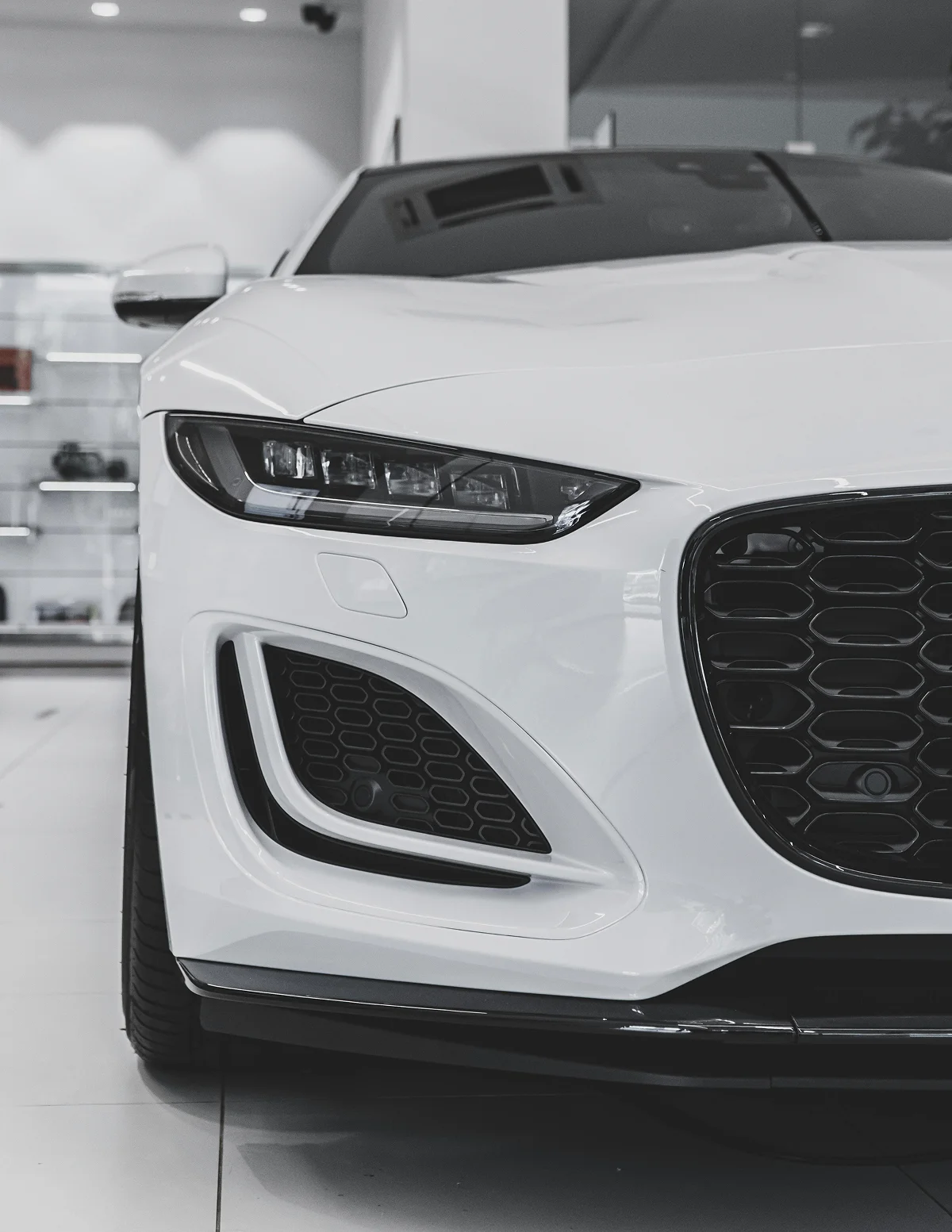 Front end headlight of white car
